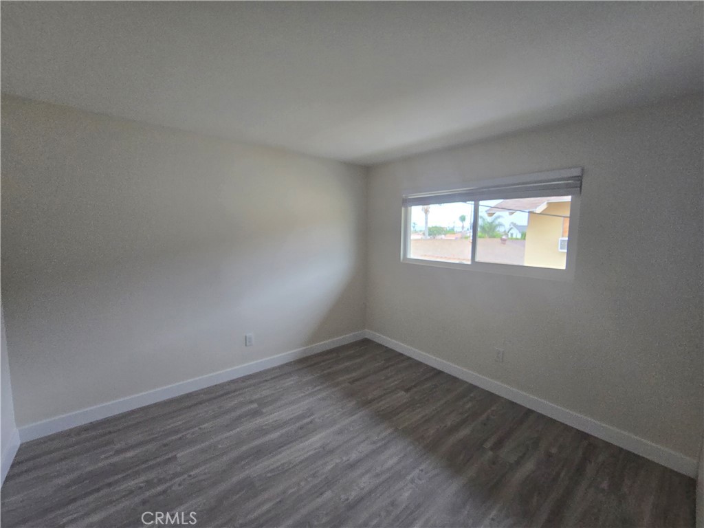 6051 Lemon Avenue, Unit C Cypress, CA 90630 - Photo 7 of 16 an empty room with wooden floor and windows