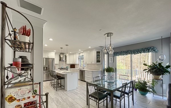 20 Warren Road Wilbraham, MA 01095 - Photo 13 of 41 a kitchen with stainless steel appliances kitchen island granite countertop a table and chairs in it