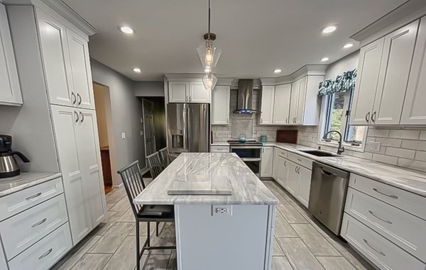 20 Warren Road Wilbraham, MA 01095 - Photo 9 of 41 a kitchen with granite countertop a refrigerator a sink a stove a microwave and island