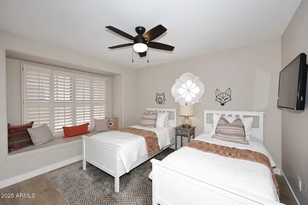 a bedroom with two beds and a chandelier