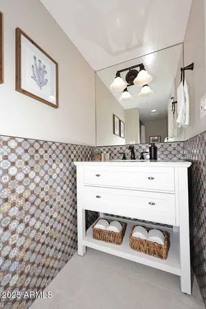 a bathroom with a sink a mirror and a shower