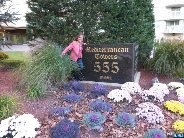a front view of a house with a yard and flowers