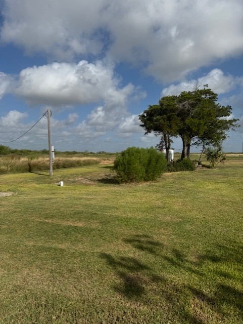 93 2nd Street Palacios, TX 77465 - Photo 13 of 24 a swimming pool with an outdoor seating and yard