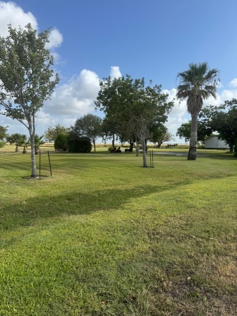 93 2nd Street Palacios, TX 77465 - Photo 2 of 24 a view of a golf course with a lake