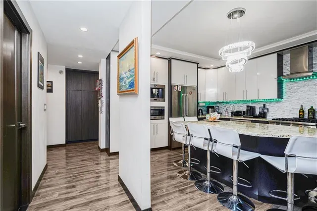 a large kitchen with a table and chairs