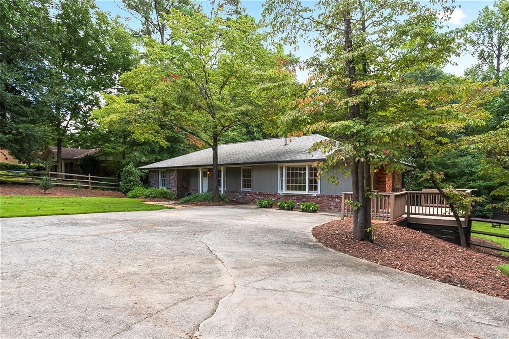 4000 Lower Roswell Road Marietta, GA 30068 - Photo 3 of 25 a front view of a house with a garden