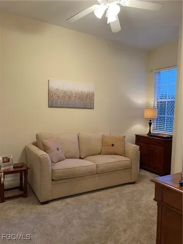 a living room with furniture and a lamp