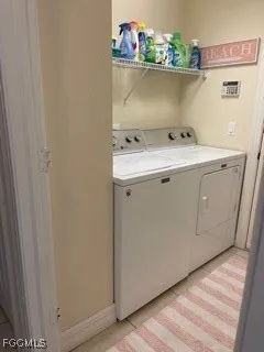 a utility room with wooden floor washer and dryer