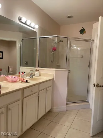a bathroom with a sink a mirror and a shower