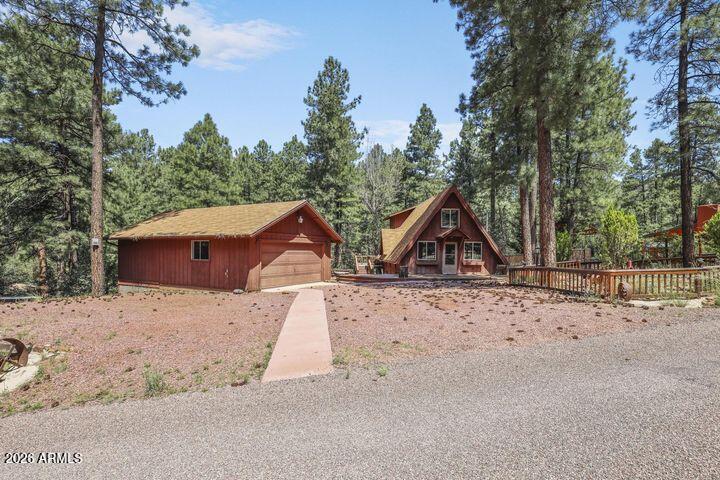 8884 Tonto Rim Drive Pine, AZ 85544 - Photo 12 of 43 a wooden bench sitting in middle of snow