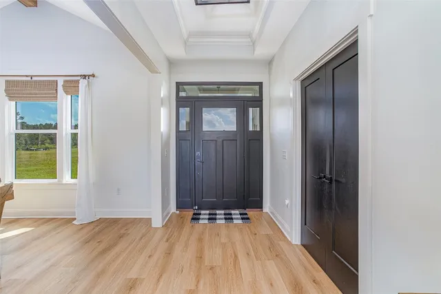 a view of a livingroom with furniture window and wooden floor