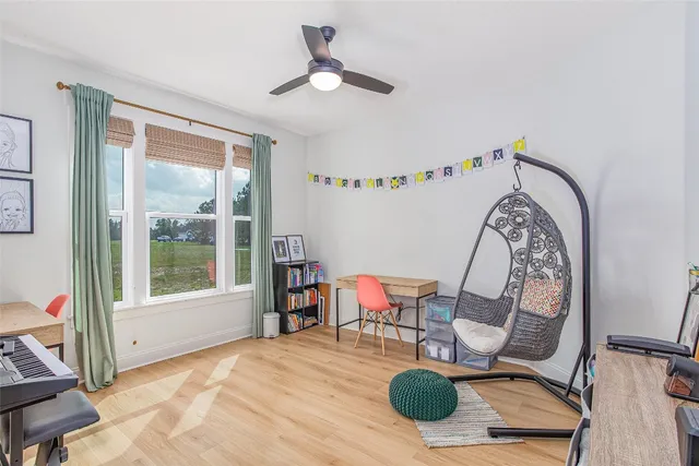 a living room with fireplace furniture and a large window