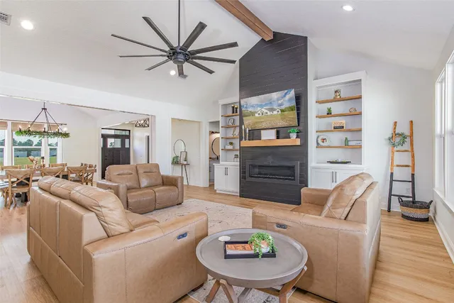 a large kitchen with kitchen island a large counter space a sink appliances and cabinets