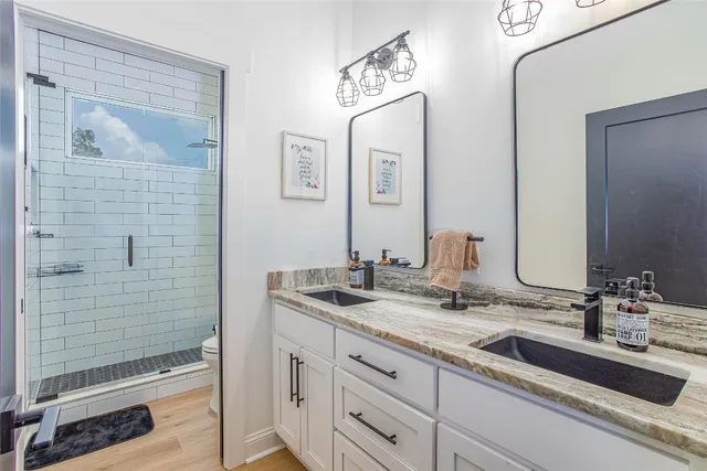 a view of a swimming pool with outdoor seating and trees in the background