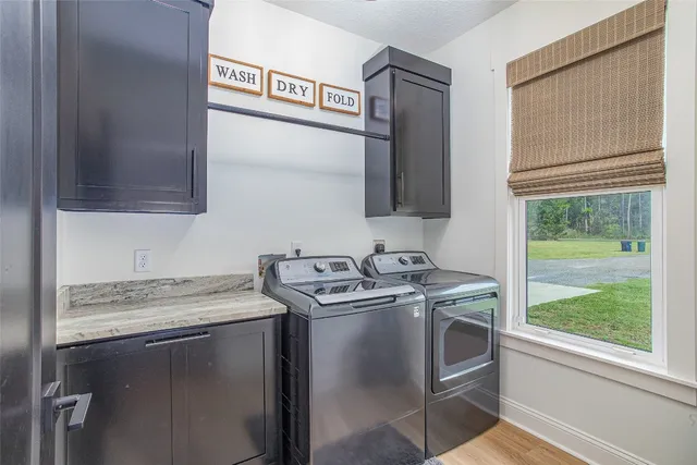a view of a swimming pool with seating area and trees in the background