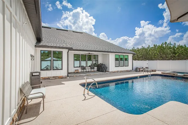 a view of swimming pool with seating area