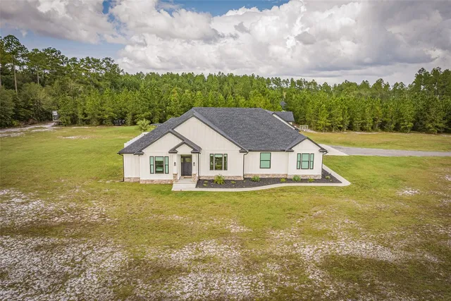 a view of a swimming pool with a yard
