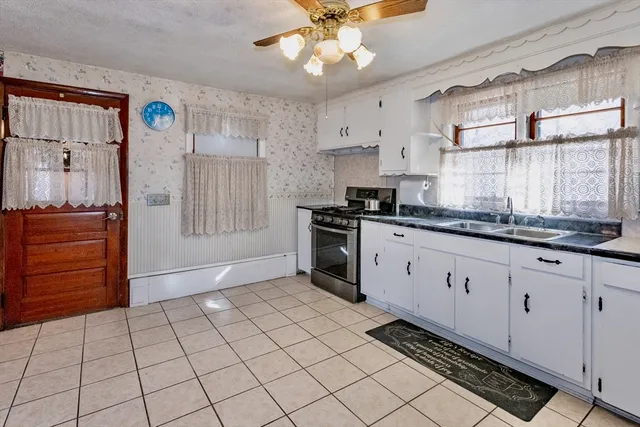 a view of an empty room with window and cabinet