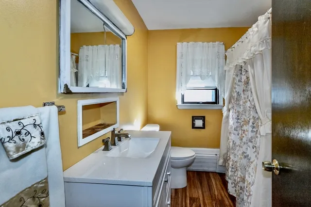a view of a room with wooden floor and fan