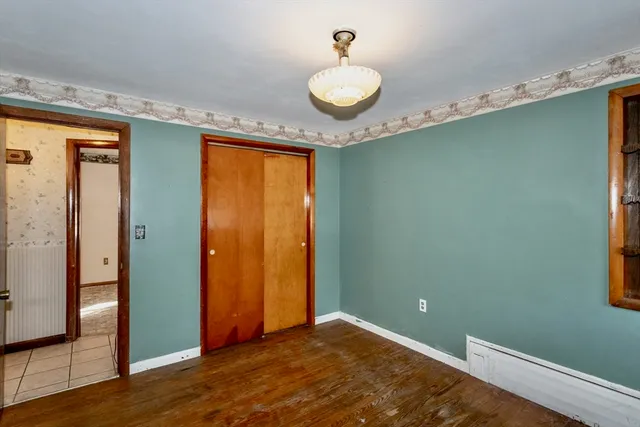 a view of a room with wooden floor and windows