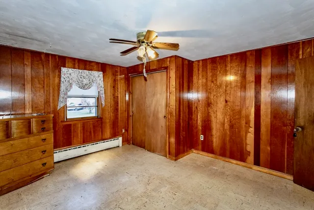 a view of a livingroom with a chandelier fan and a window
