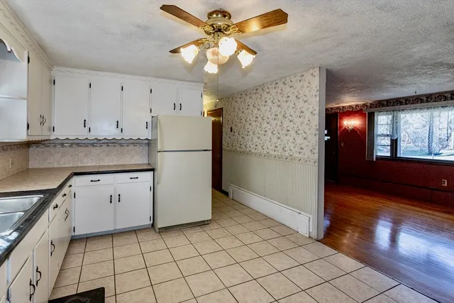 a kitchen with granite countertop a stove sink and cabinets