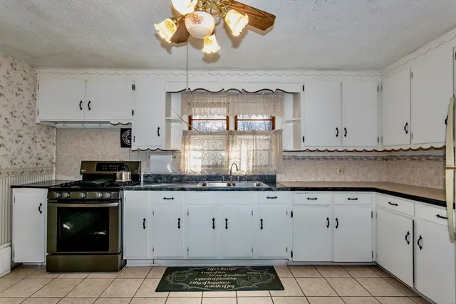 a kitchen with stainless steel appliances a cabinets and a stove top oven