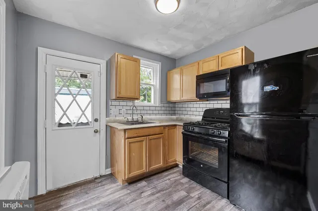 a kitchen with a refrigerator stove and sink