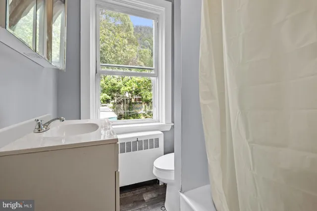 a bathroom with a sink toilet and a tub