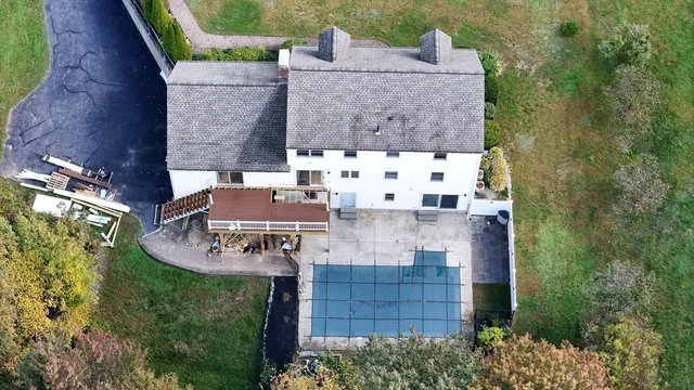 an aerial view of a house with a yard