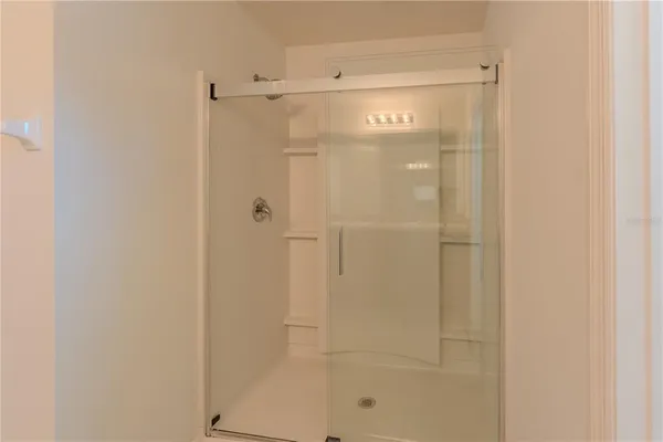 a bathroom with a glass shower door