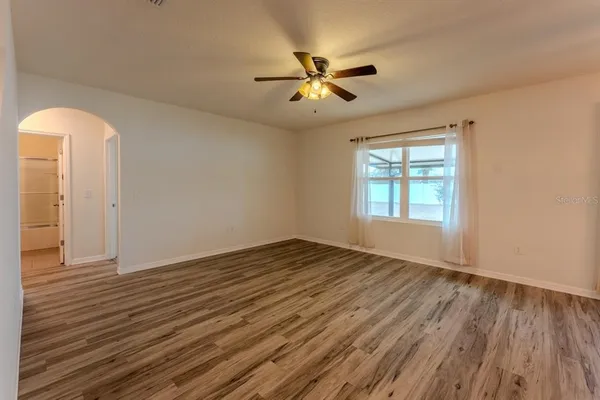 wooden floor in an empty room with a window