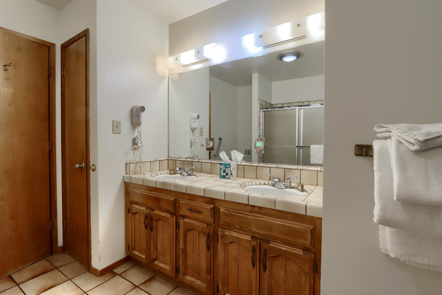 8041 Chilnualna Falls Road Wawona, CA 95389 - Photo 15 of 46 a bathroom with a double vanity sink and a mirror