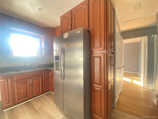 a view of a hallway with entryway wooden floor and front door