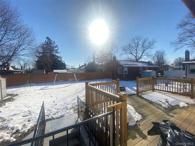 a view of a kitchen with wooden floor and a refrigerator