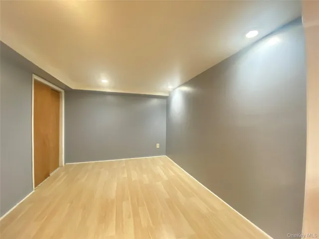 a view of a kitchen with wooden floor and a refrigerator