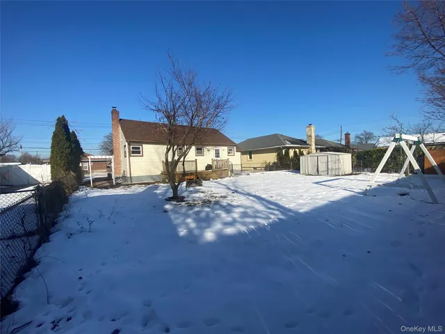 a view of an empty room with window and fireplace