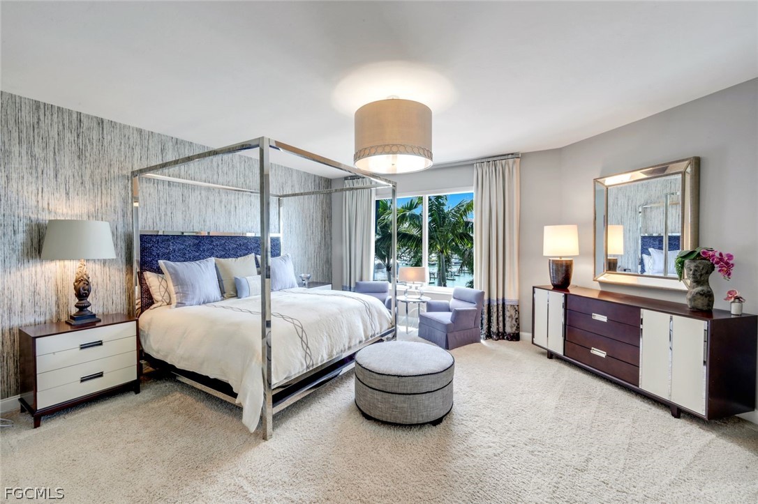 13675 Vanderbilt Drive, Unit 406 Naples, FL 34110 - Photo 16 of 43 a spacious bedroom with a bed and a large window