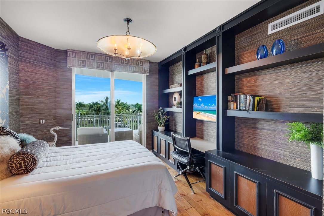13675 Vanderbilt Drive, Unit 406 Naples, FL 34110 - Photo 24 of 43 a bedroom with a bed and a large window