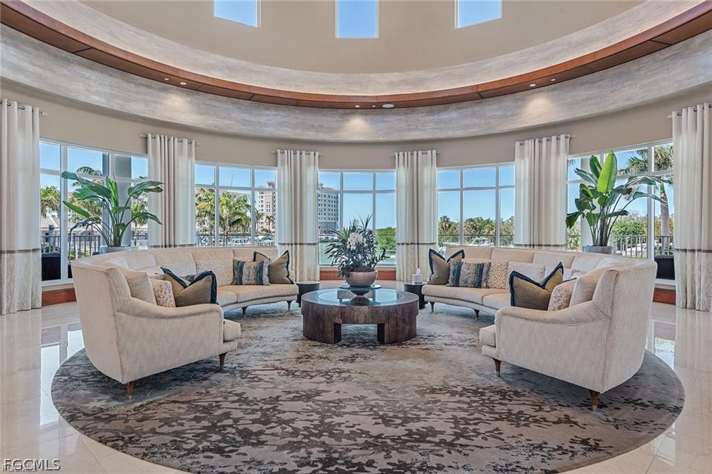 13675 Vanderbilt Drive, Unit 406 Naples, FL 34110 - Photo 38 of 43 a living room with furniture and a large window