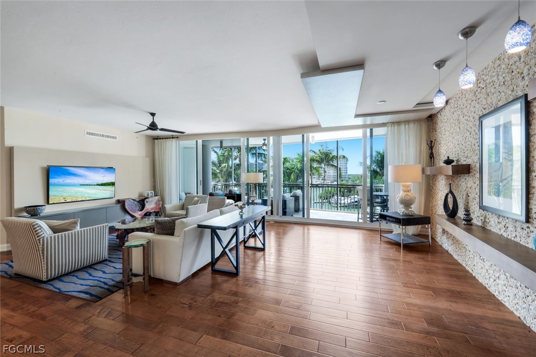 13675 Vanderbilt Drive, Unit 406 Naples, FL 34110 - Photo 5 of 43 a living room with furniture and a large window