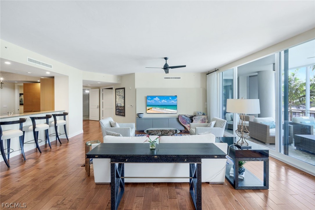 13675 Vanderbilt Drive, Unit 406 Naples, FL 34110 - Photo 7 of 43 a view of a dining room with furniture window and wooden floor