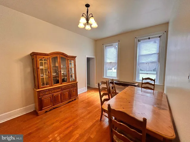 a living room with furniture flat screen tv and window