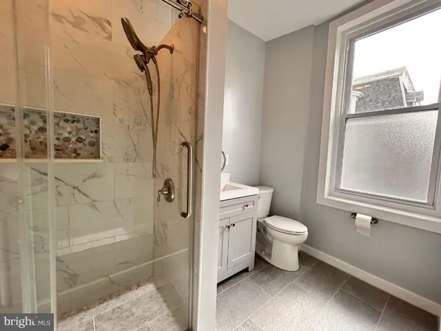 a bathroom with a toilet sink and a shower