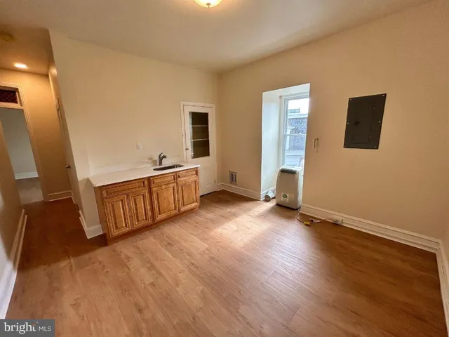 a view of a livingroom with wooden floor and stairs