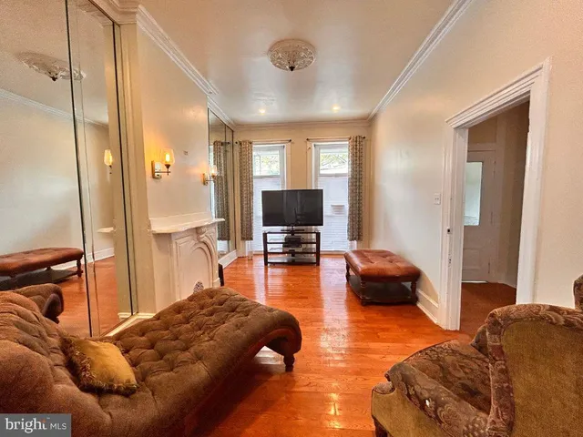 a bedroom with furniture and a flat screen tv