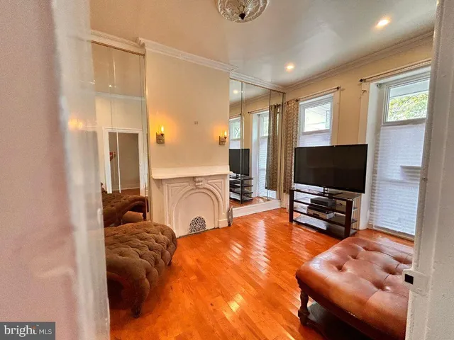 a living room with furniture and a flat screen tv