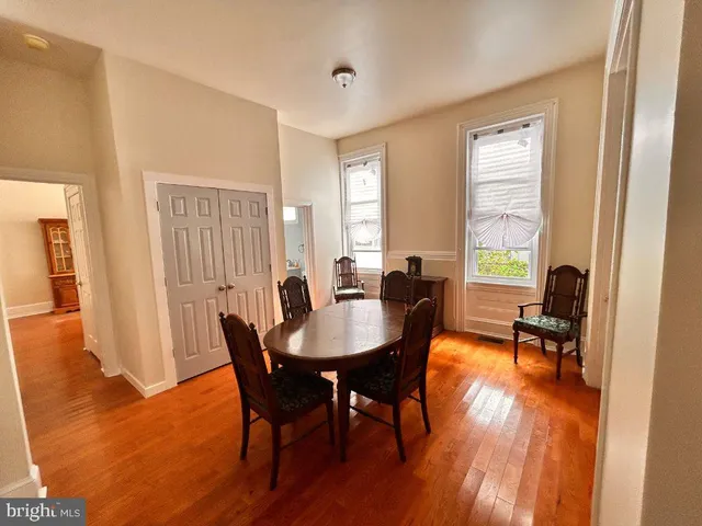a dining room with furniture and wooden floor