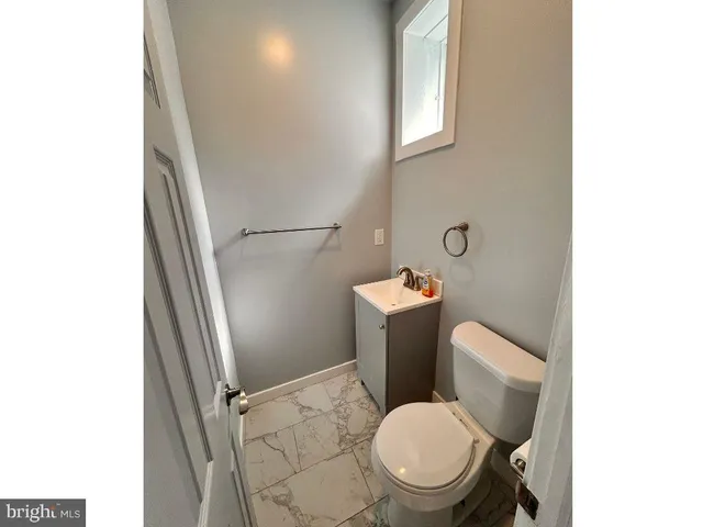a white toilet sitting next to a bathroom sink