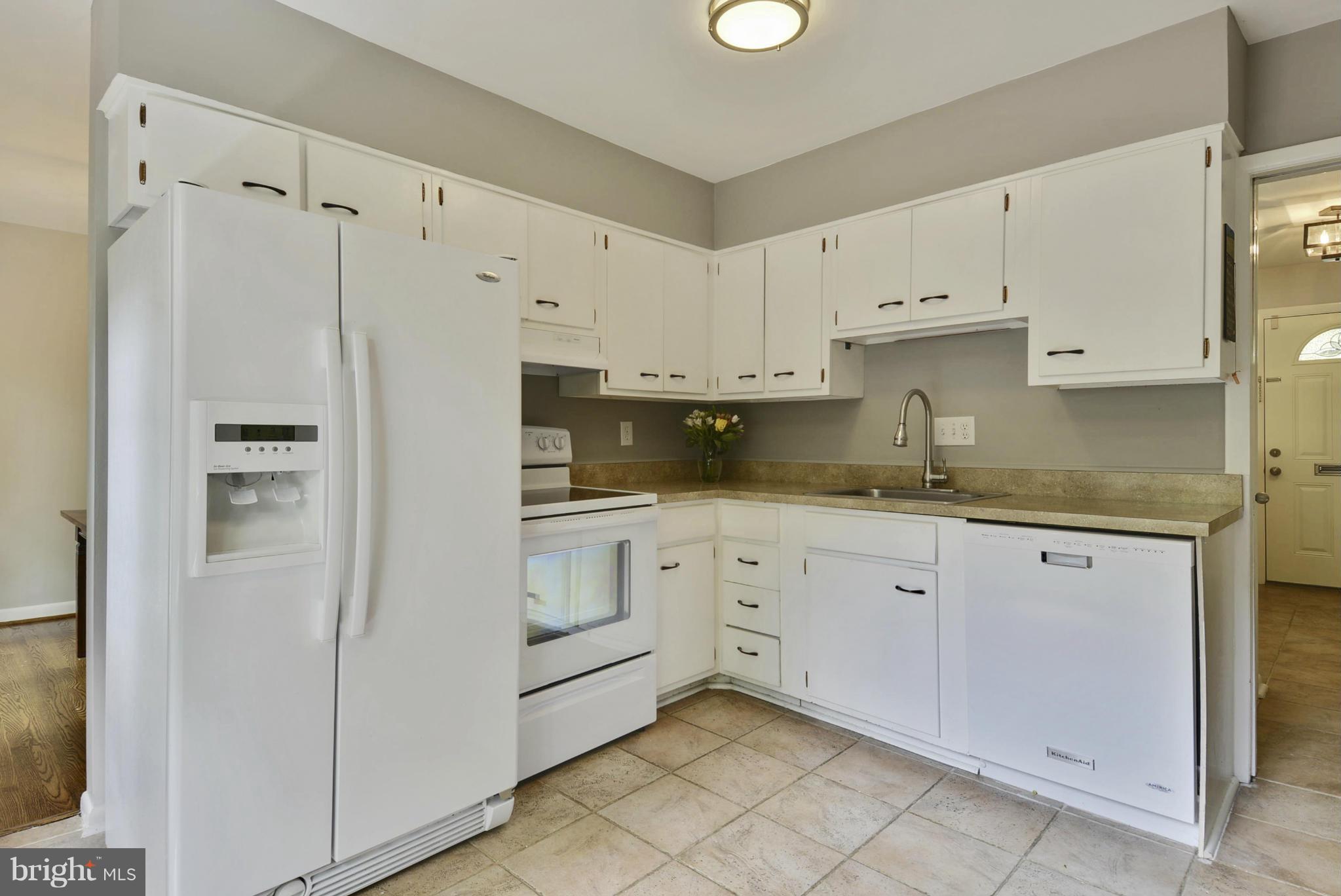 21 Parkside Road Silver Spring, MD 20910 - Photo 9 of 29 a kitchen with granite countertop white cabinets and refrigerator